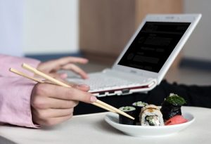 eating sushi at computer business idea