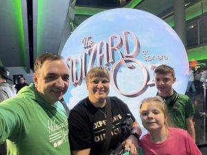 Matt Paulson, wife, and two kids attend Wizard of Oz show.